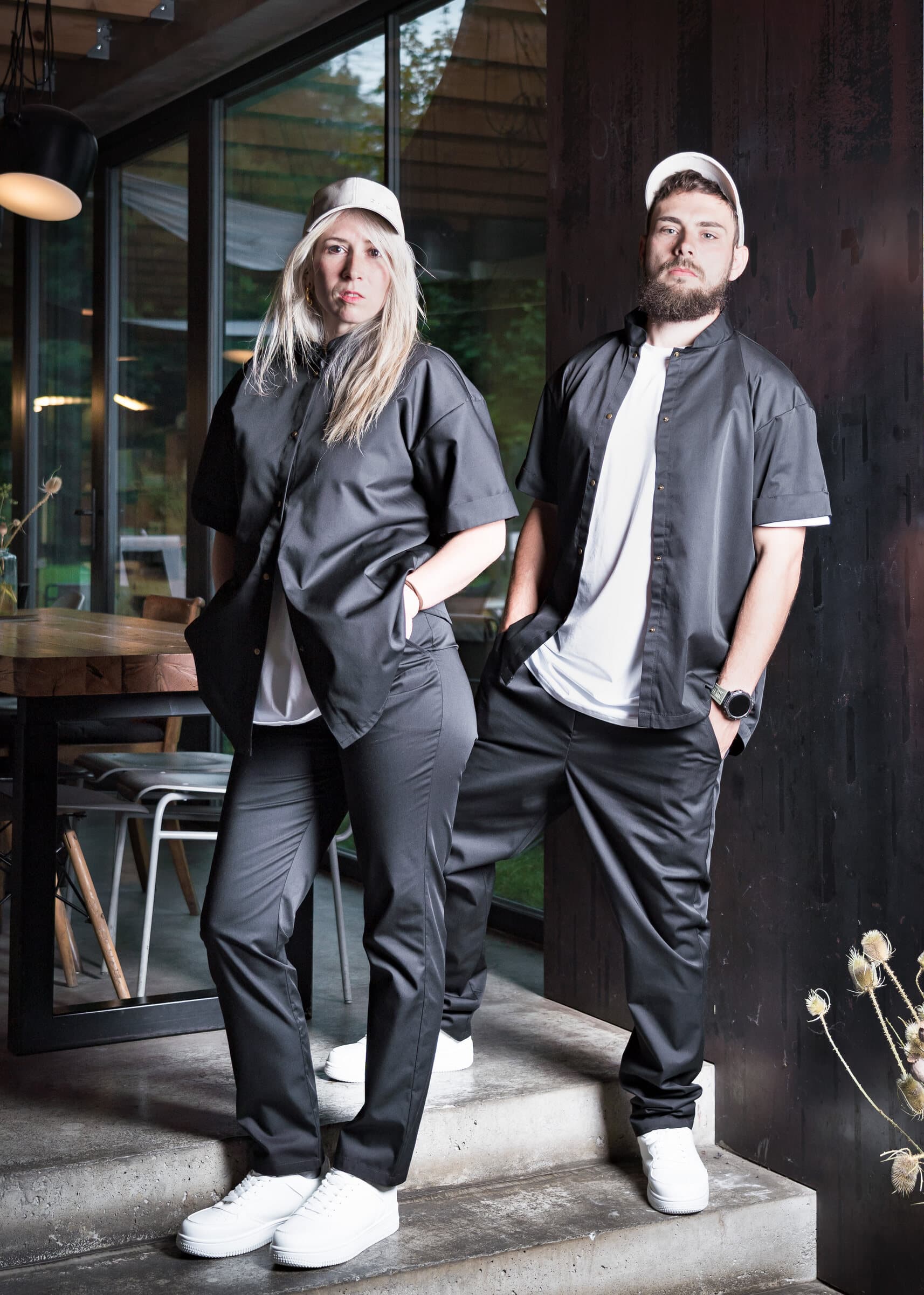 Two people in slate shirt-style chef tops