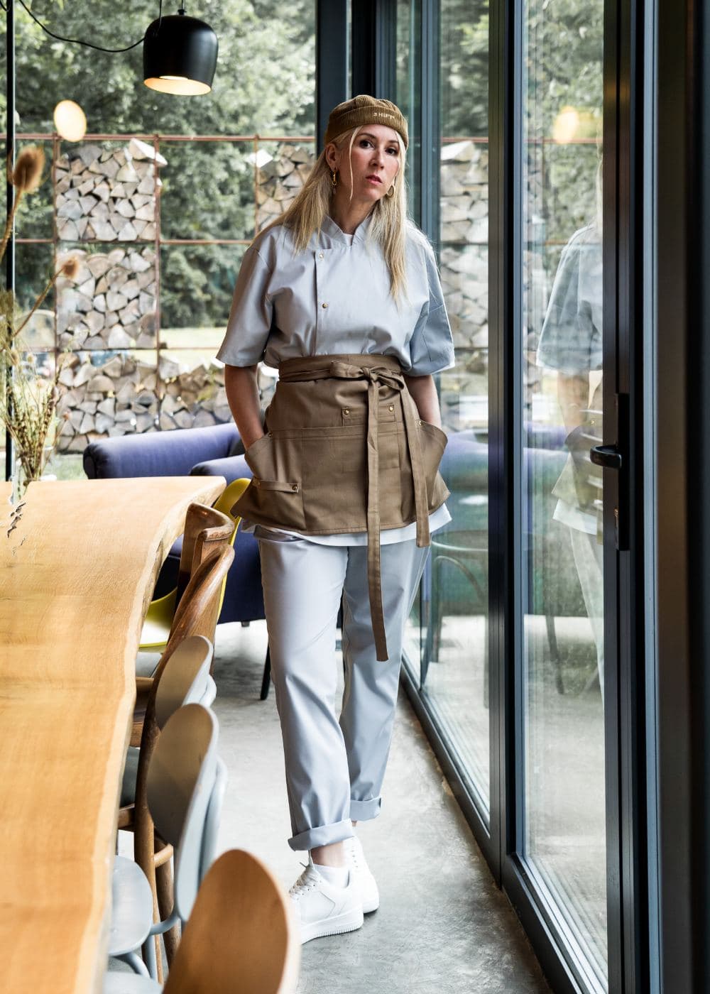 Waist apron tied over a mist grey chef top